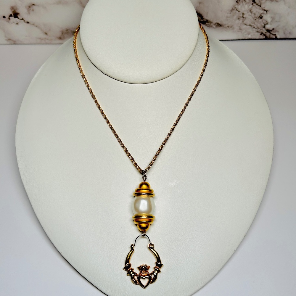 Upcycled Pendant Necklace features a gold tone Claddagh and faux Pearl pendant.